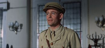 Movie still from “Lawrence of Arabia” (1962), directed by David Lean – A man in a military uniform looking up at the sky; Close Up shot, Low angle