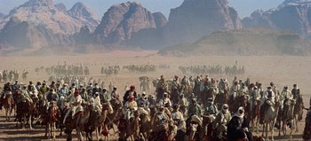Movie still from “Lawrence of Arabia” (1962), directed by David Lean – A large group of people on horses in the desert; Extreme Wide shot, High angle