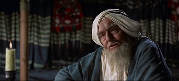 Movie still from “Lawrence of Arabia” (1962), directed by David Lean – An old man with long white hair and a white beard; Close Up shot, Over the shoulder angle