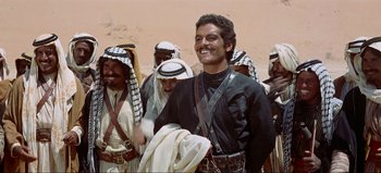 Movie still from “Lawrence of Arabia” (1962), directed by David Lean – A group of men standing next to each other; Medium shot, Low angle