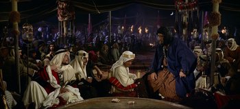 Movie still from “Lawrence of Arabia” (1962), directed by David Lean – A group of men sitting around a table; Wide shot, High angle