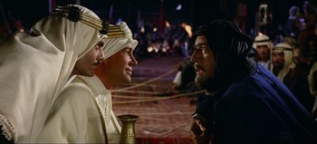 Movie still from “Lawrence of Arabia” (1962), directed by David Lean – A group of men standing next to each other; Medium shot, Over the shoulder angle