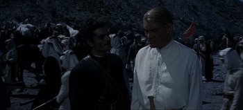 Movie still from “Lawrence of Arabia” (1962), directed by David Lean – Two men standing next to each other in a crowd; Medium shot, Over the shoulder angle