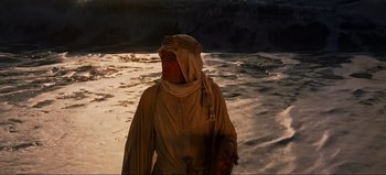 Movie still from “Lawrence of Arabia” (1962), directed by David Lean – A person standing on a beach near the ocean; Medium shot, High angle