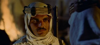 Movie still from “Lawrence of Arabia” (1962), directed by David Lean – A person wearing a headdress; Close Up shot, Over the shoulder angle