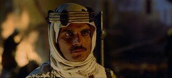 Movie still from “Lawrence of Arabia” (1962), directed by David Lean – A person wearing a headdress; Close Up shot, Over the shoulder angle