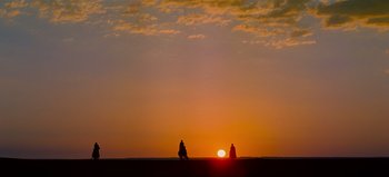 Movie still from “Lawrence of Arabia” (1962), directed by David Lean – Two people are standing on a beach at sunset; Extreme Wide shot, Low angle