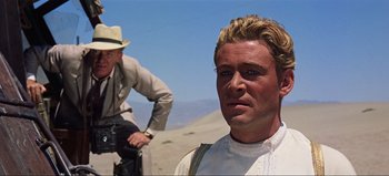 Movie still from “Lawrence of Arabia” (1962), directed by David Lean – A man in a white shirt and a man in a tan hat; Close Up shot, Over the shoulder angle