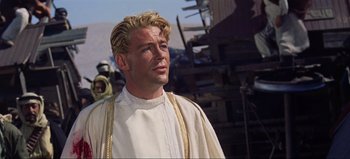 Movie still from “Lawrence of Arabia” (1962), directed by David Lean – A person wearing a robe; Close Up shot, Over the shoulder angle