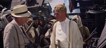 Movie still from “Lawrence of Arabia” (1962), directed by David Lean – A group of men standing next to each other; Medium shot, Over the shoulder angle