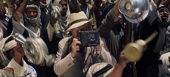 Movie still from “Lawrence of Arabia” (1962), directed by David Lean – A man taking a picture of a crowd of people; Medium shot, High angle