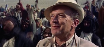 Movie still from “Lawrence of Arabia” (1962), directed by David Lean – An older man wearing a hat looking up at a crowd; Close Up shot, Low angle