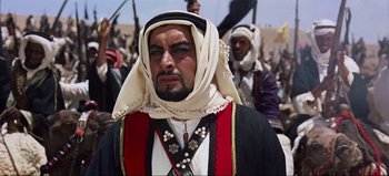 Movie still from “Lawrence of Arabia” (1962), directed by David Lean – A person wearing a headdress; Medium shot, Low angle