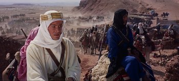 Movie still from “Lawrence of Arabia” (1962), directed by David Lean – Two men are sitting on top of a hill; Medium shot, Over the shoulder angle