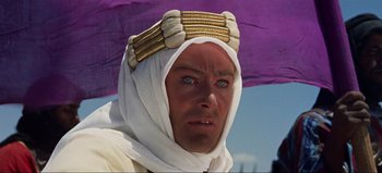 Movie still from “Lawrence of Arabia” (1962), directed by David Lean – A person wearing a headdress; Close Up shot, Over the shoulder angle