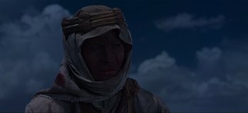 Movie still from “Lawrence of Arabia” (1962), directed by David Lean – A man wearing a head covering in the night sky; Close Up shot, Low angle