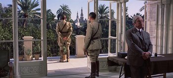 Movie still from “Lawrence of Arabia” (1962), directed by David Lean – Two men dressed in military uniforms standing on a balcony; Wide shot, Low angle
