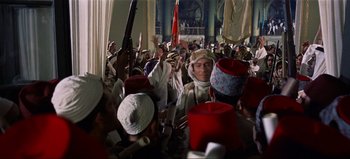 Movie still from “Lawrence of Arabia” (1962), directed by David Lean – A group of people standing in a room; Wide shot, High angle
