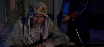 Movie still from “Lawrence of Arabia” (1962), directed by David Lean – A man in a costume sitting in front of another man; Medium shot, Over the shoulder angle