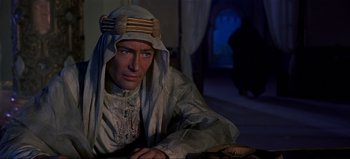 Movie still from “Lawrence of Arabia” (1962), directed by David Lean – A man wearing a white robe and a head covering; Medium shot, Over the shoulder angle