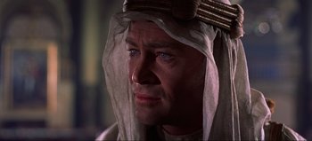 Movie still from “Lawrence of Arabia” (1962), directed by David Lean – A person wearing a headdress; Close Up shot, Over the shoulder angle