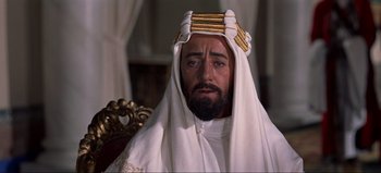 Movie still from “Lawrence of Arabia” (1962), directed by David Lean – A person wearing a headdress; Close Up shot, Over the shoulder angle