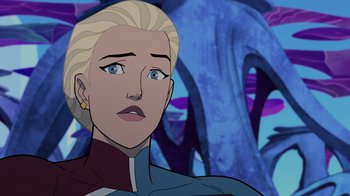 Movie still from “Legion of Super-Heroes” (2023), directed by Jeff Wamester – A woman with blonde hair is looking at the camera; Close Up shot, Over the shoulder angle