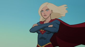 Movie still from “Legion of Super-Heroes” (2023), directed by Jeff Wamester – A woman with blonde hair and a red and blue cape; Medium shot, Over the shoulder angle