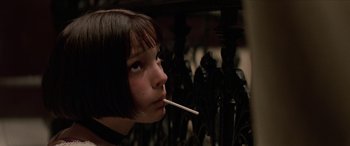 Movie still from “Léon: The Professional” (1994), directed by Luc Besson – A young girl with a cigarette in her mouth; Close Up shot, Low angle