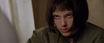 Movie still from “Léon: The Professional” (1994), directed by Luc Besson – A person wearing a green shirt; Close Up shot, Low angle