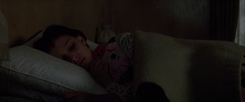 Movie still from “Léon: The Professional” (1994), directed by Luc Besson – A child is sleeping in a bed with a stuffed animal; Close Up shot, High angle