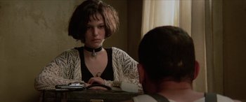 Movie still from “Léon: The Professional” (1994), directed by Luc Besson – A woman sitting in front of a mirror looking at a man; Close Up shot, Over the shoulder angle