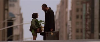 Movie still from “Léon: The Professional” (1994), directed by Luc Besson – A man and a young girl standing next to each other; Medium shot, Over the shoulder angle