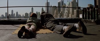 Movie still from “Léon: The Professional” (1994), directed by Luc Besson – A couple of people that are laying on the ground; Wide shot, Overhead angle