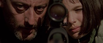 Movie still from “Léon: The Professional” (1994), directed by Luc Besson – A man and a woman looking at each other through a pair of binoculars; Extreme Close Up shot, Low angle