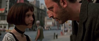 Movie still from “Léon: The Professional” (1994), directed by Luc Besson – A man and a woman face to face on the street; Close Up shot, Over the shoulder angle