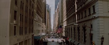Movie still from “Léon: The Professional” (1994), directed by Luc Besson – An american flag flies on the side of the street; Extreme Wide shot, High angle