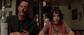Movie still from “Léon: The Professional” (1994), directed by Luc Besson – A man and a woman sitting next to each other in a restaurant; Close Up shot, Low angle