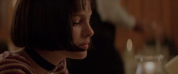 Movie still from “Léon: The Professional” (1994), directed by Luc Besson – A young woman with short black hair looking to her left; Close Up shot, Low angle