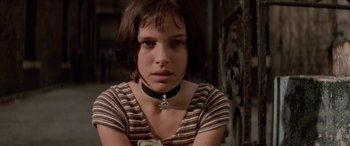 Movie still from “Léon: The Professional” (1994), directed by Luc Besson – A young woman wearing a black and white striped shirt; Close Up shot, Low angle