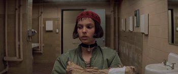 Movie still from “Léon: The Professional” (1994), directed by Luc Besson – A person with a red hat and a green jacket; Close Up shot, Low angle