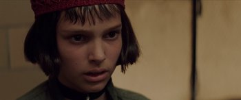 Movie still from “Léon: The Professional” (1994), directed by Luc Besson – A person wearing a hat; Close Up shot, Over the shoulder angle