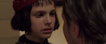 Movie still from “Léon: The Professional” (1994), directed by Luc Besson – A young girl crying in front of another girl; Close Up shot, Over the shoulder angle