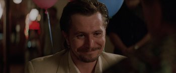 Movie still from “Léon: The Professional” (1994), directed by Luc Besson – A person wearing a suit; Close Up shot, Over the shoulder angle