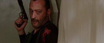 Movie still from “Léon: The Professional” (1994), directed by Luc Besson – A person wearing a black shirt; Close Up shot, Low angle