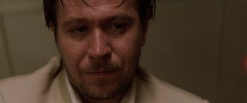 Movie still from “Léon: The Professional” (1994), directed by Luc Besson – A person wearing a white shirt; Close Up shot, Low angle