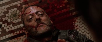 Movie still from “Léon: The Professional” (1994), directed by Luc Besson – A person with blood all over his face; Close Up shot, Overhead angle