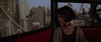 Movie still from “Léon: The Professional” (1994), directed by Luc Besson – A woman sitting on a bus looking out the window; Close Up shot, Over the shoulder angle