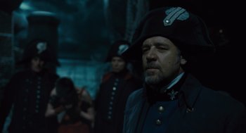 Movie still from “Les Misérables” (2012), directed by Tom Hooper – A man in a military uniform and a hat; Close Up shot, Over the shoulder angle