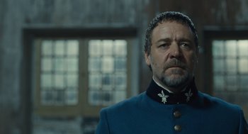 Movie still from “Les Misérables” (2012), directed by Tom Hooper – A person wearing a suit and tie; Close Up shot, Low angle